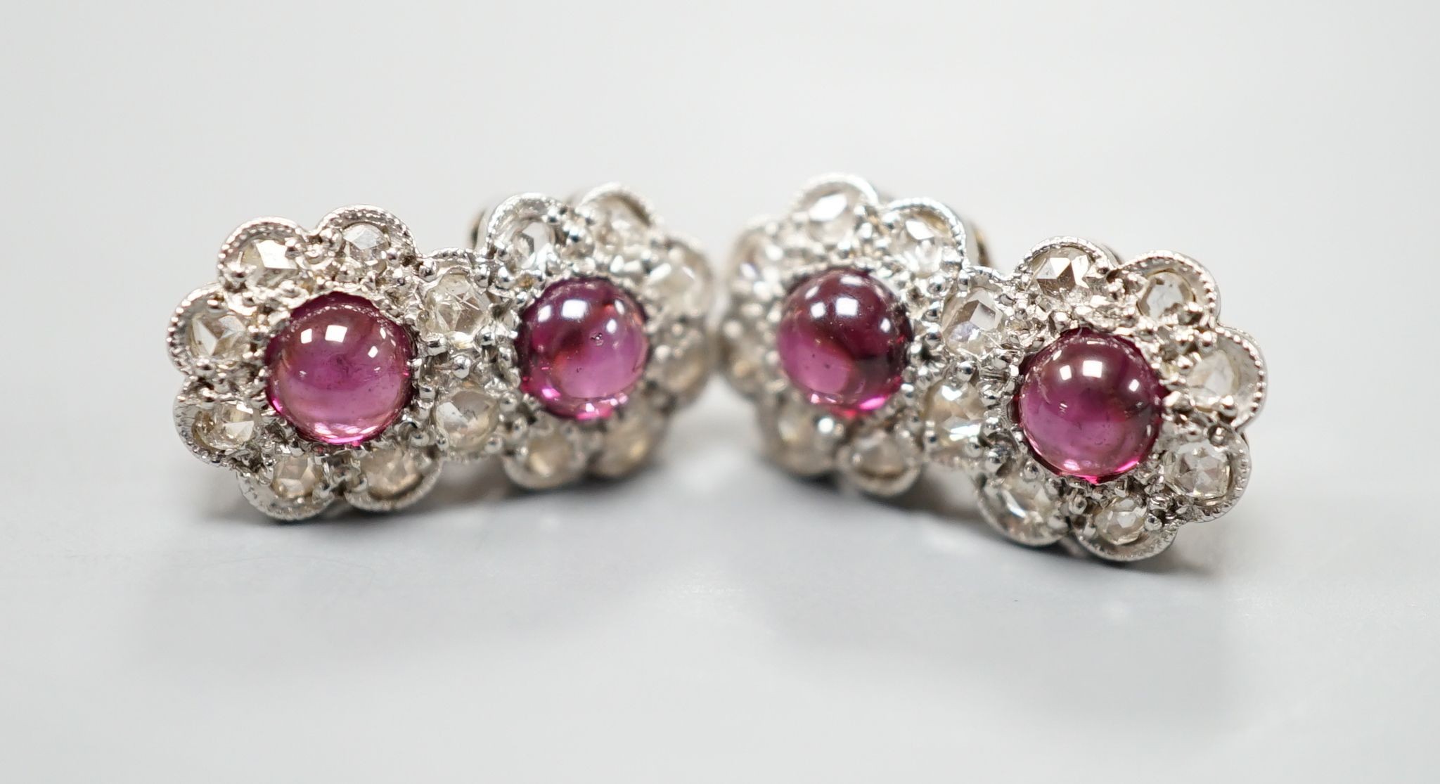 A pair of cabochon garnet and diamond set double cluster earrings (lacking butterflies), 14mm, gross weight 2.5 grams.